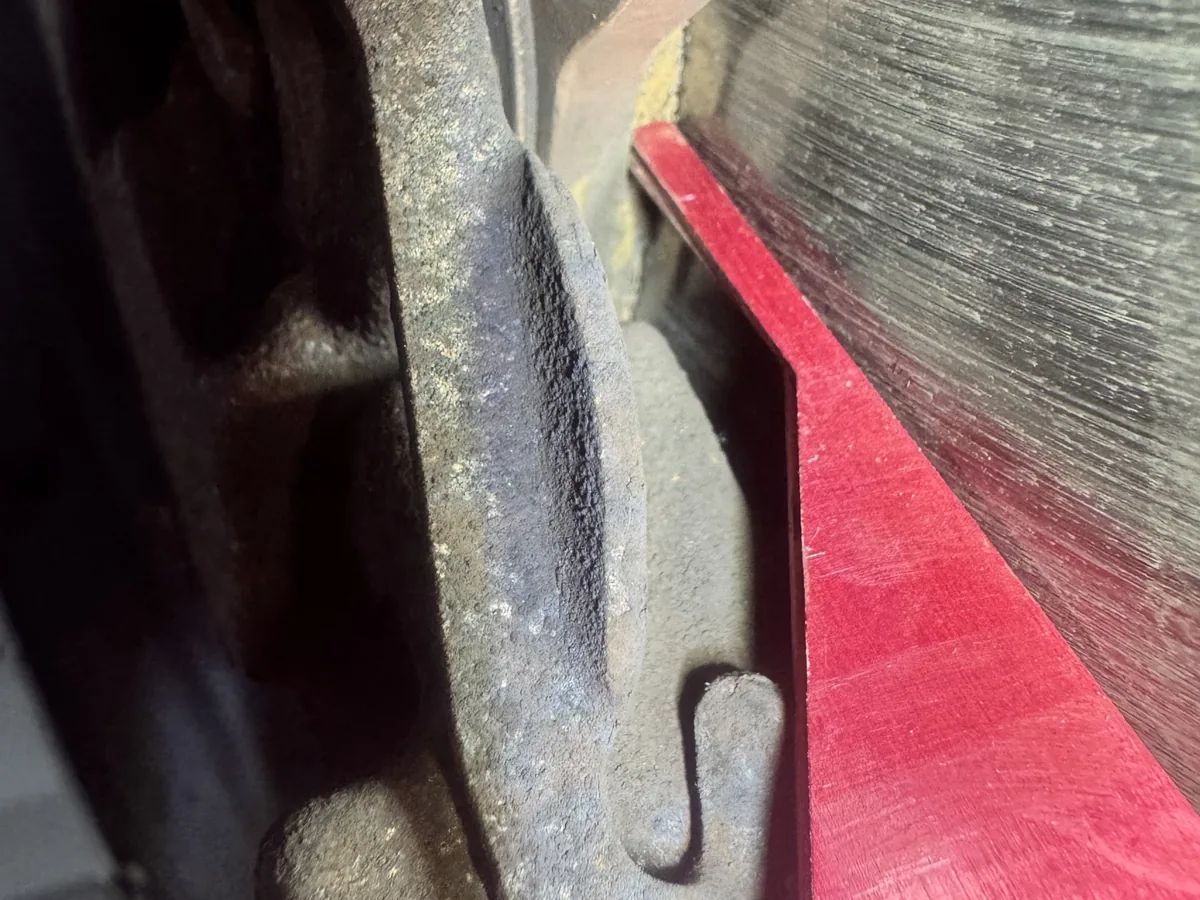 Measuring brake pad thickness with a pad gauge at our Royston workshop