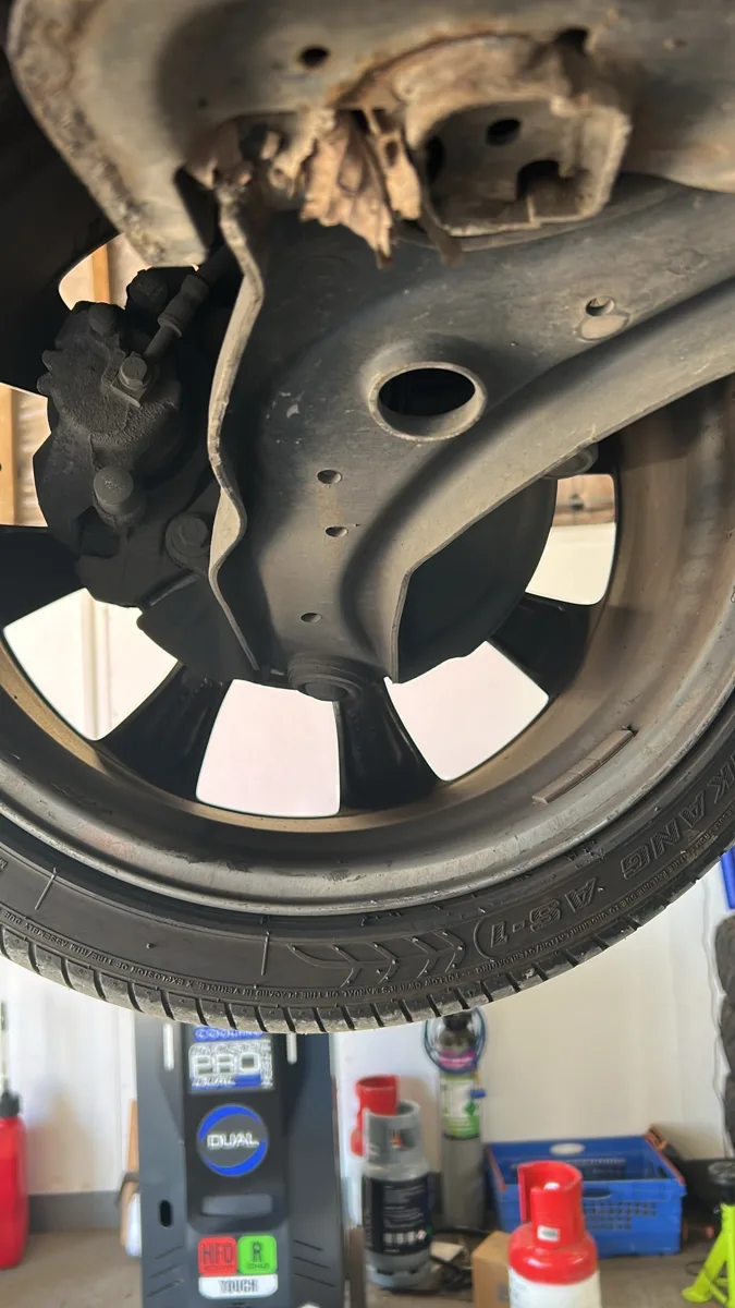 Car on a lift for a front wheel inspection