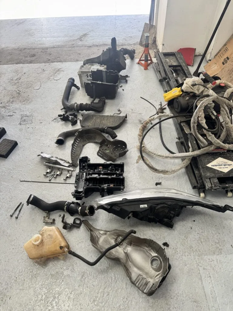 Parts laid out on the workshop floor during a Ford 1.0 EcoBoost wet belt replacement