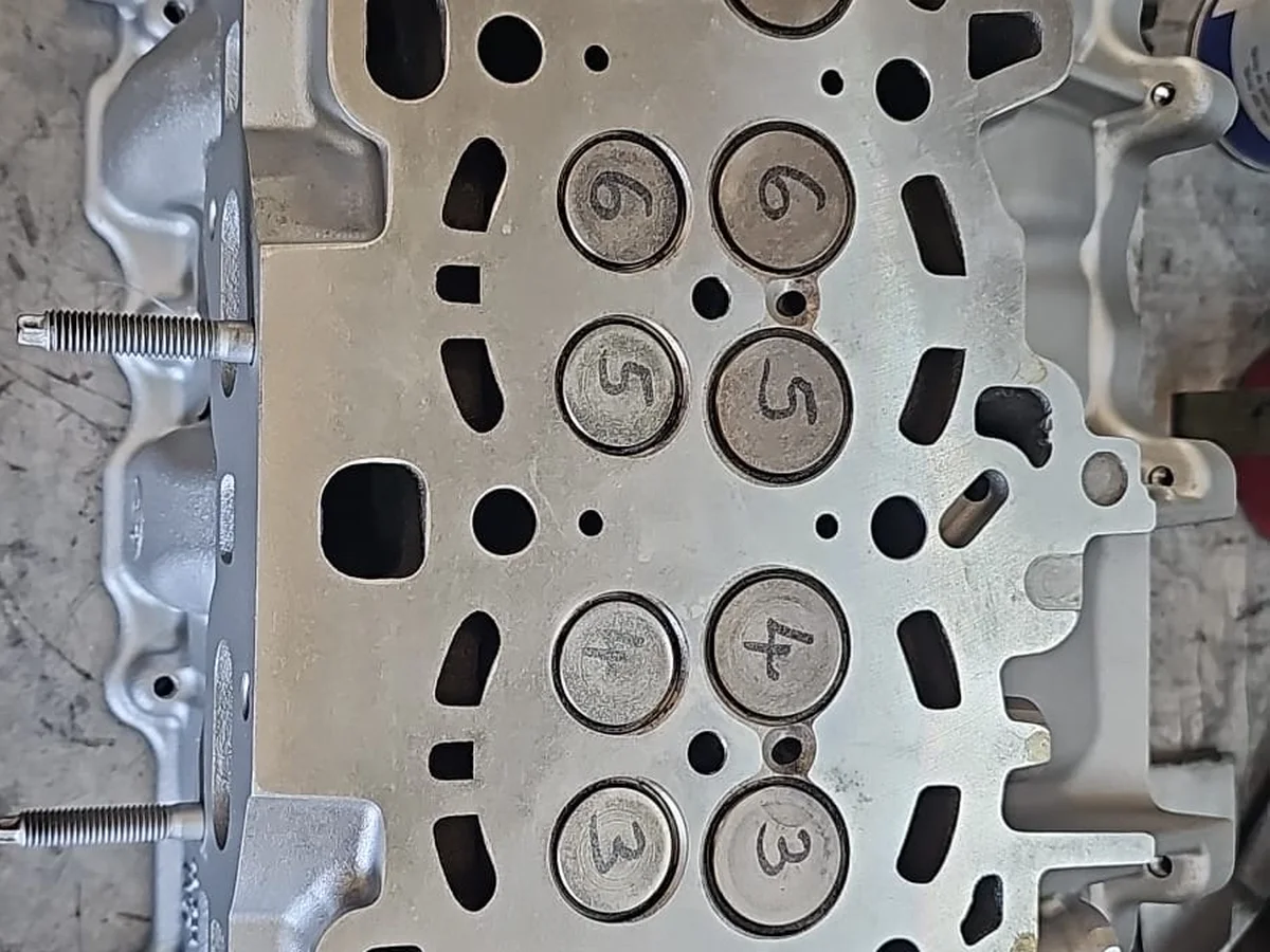 Cylinder head face with numbered valves during an engine rebuild at our Royston workshop