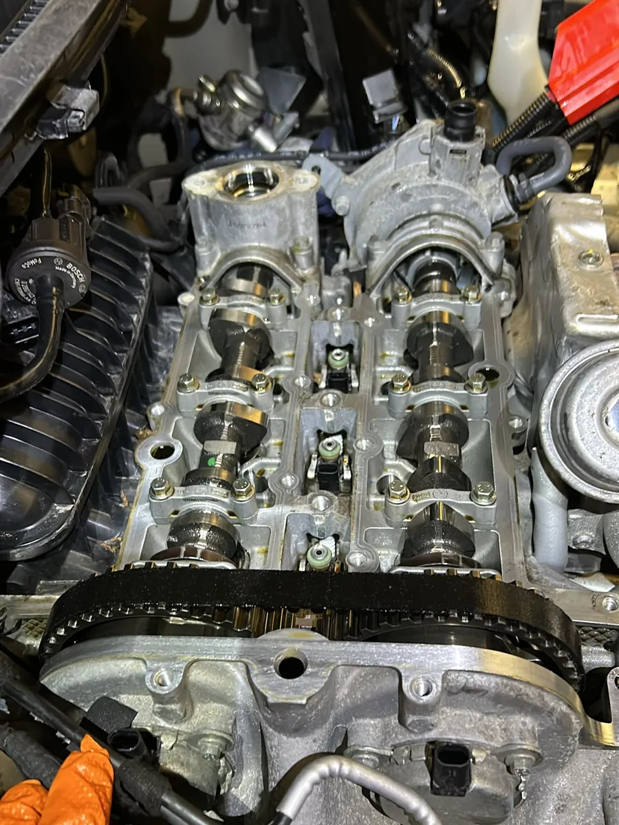 Close-up of the camshafts and timing belt on a Ford Fiesta 1.0 EcoBoost with the cam cover removed