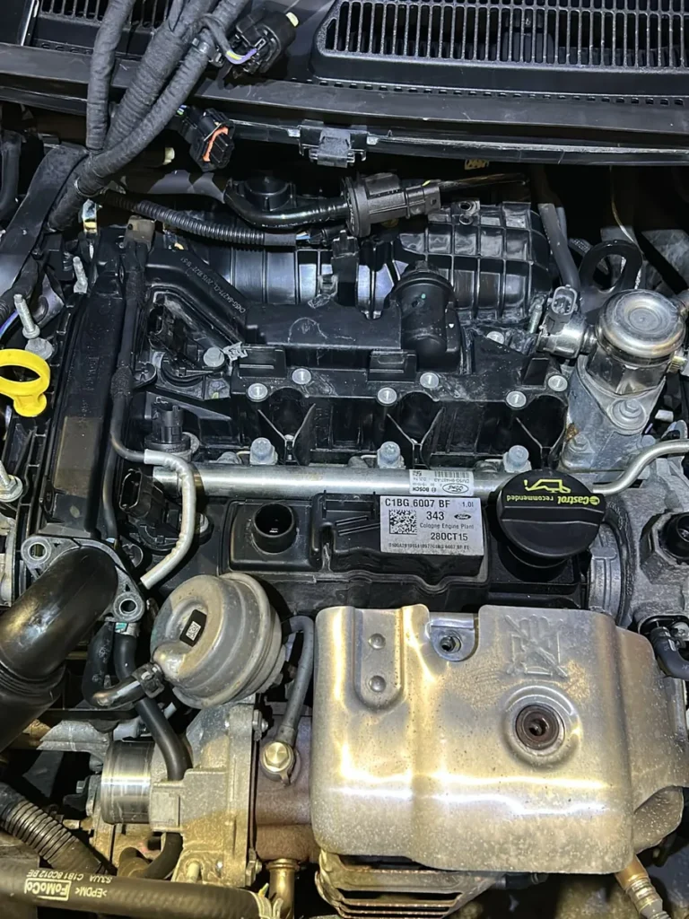 Ford Fiesta 1.0 EcoBoost engine bay with the intake manifold and cam cover still fitted, before a wet belt replacement at our Swindon workshop