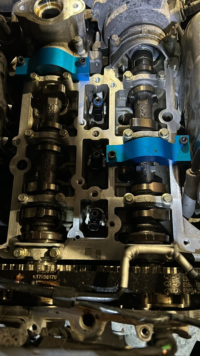 Ford Fiesta 1.0 EcoBoost cylinder head with the cam cover off and both camshafts held with blue camshaft locking tools