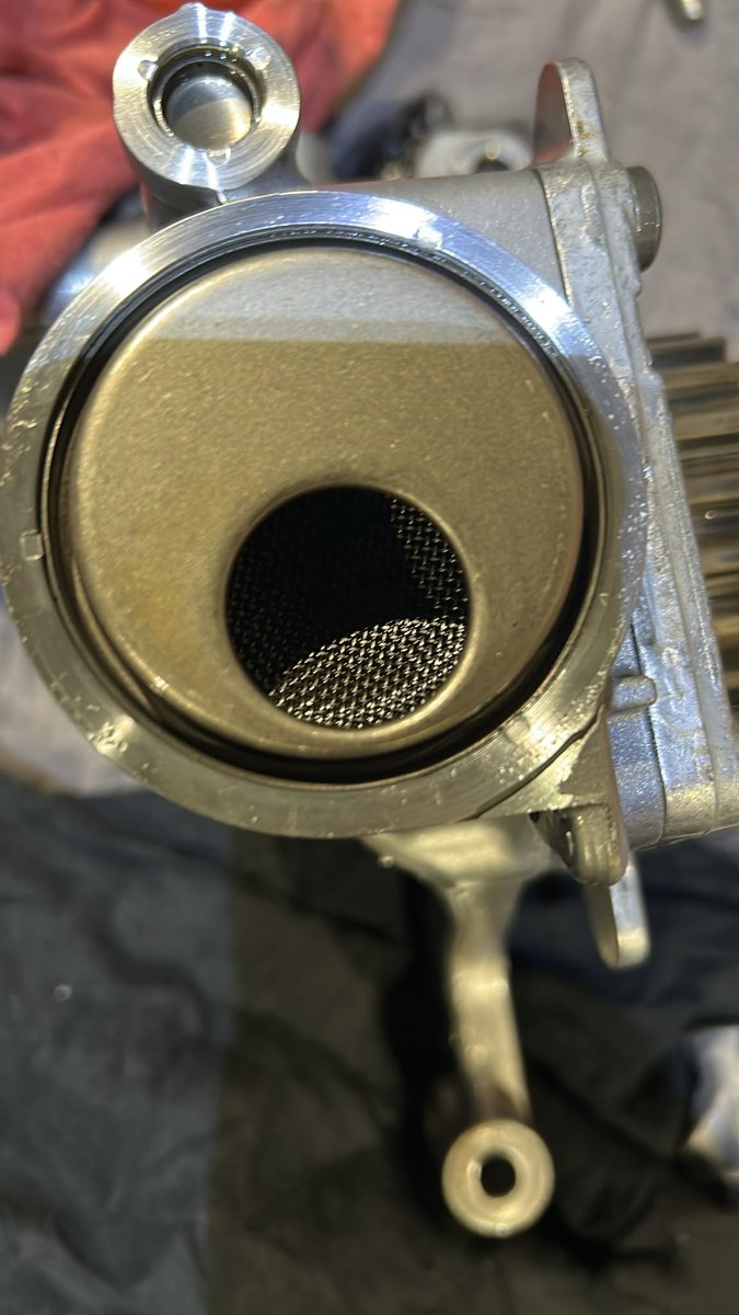 Close-up of the oil pump pickup strainer mesh from a Ford Fiesta 1.0 EcoBoost