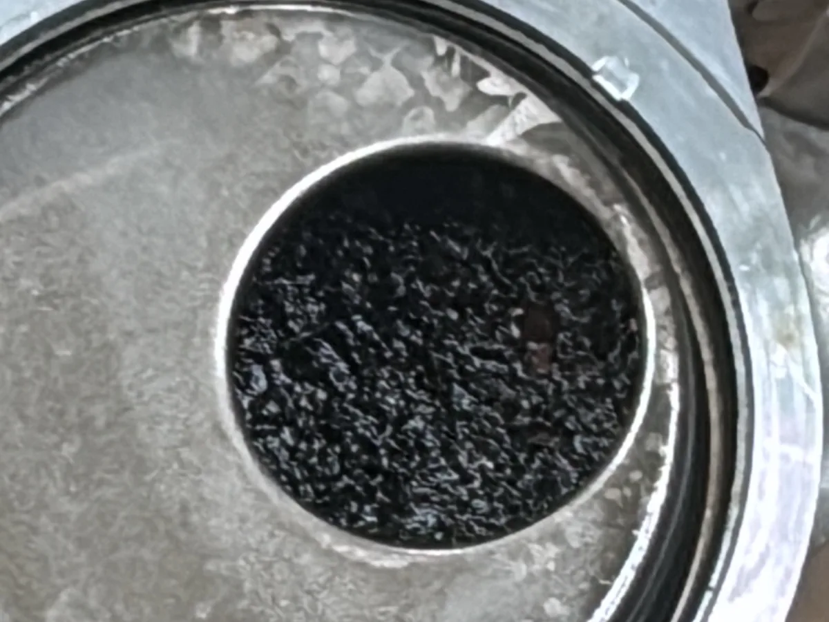 Oil pump with its strainer opening blocked by black wet belt debris, found at our Royston workshop