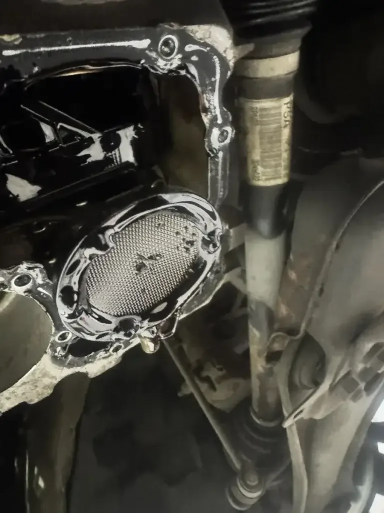 1.2 PureTech oil pickup strainer covered in sludge with belt debris on the mesh